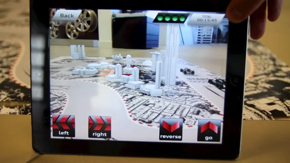 The AR race track on the table in the iPad view: controls at the bottom of the screen