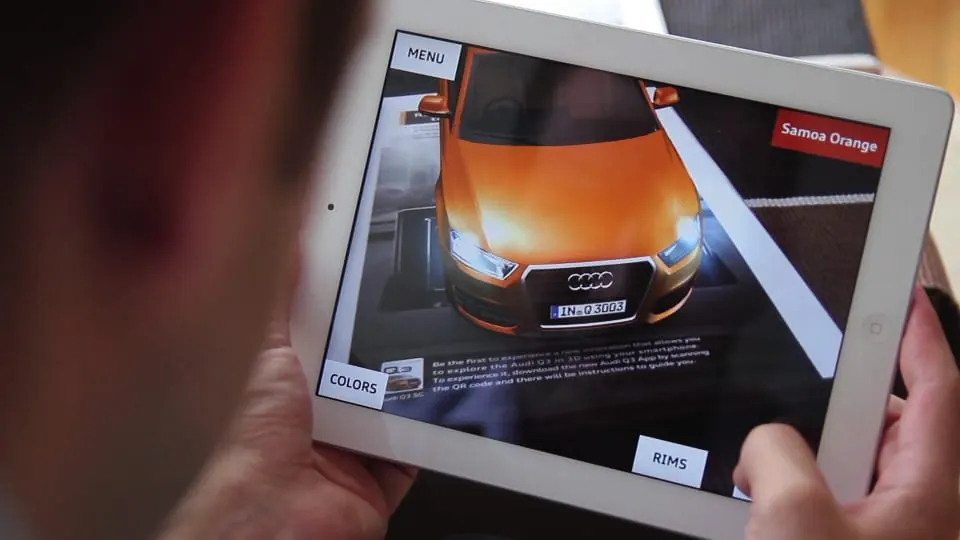 An orange Audi Q3 in AR on an iPad screen