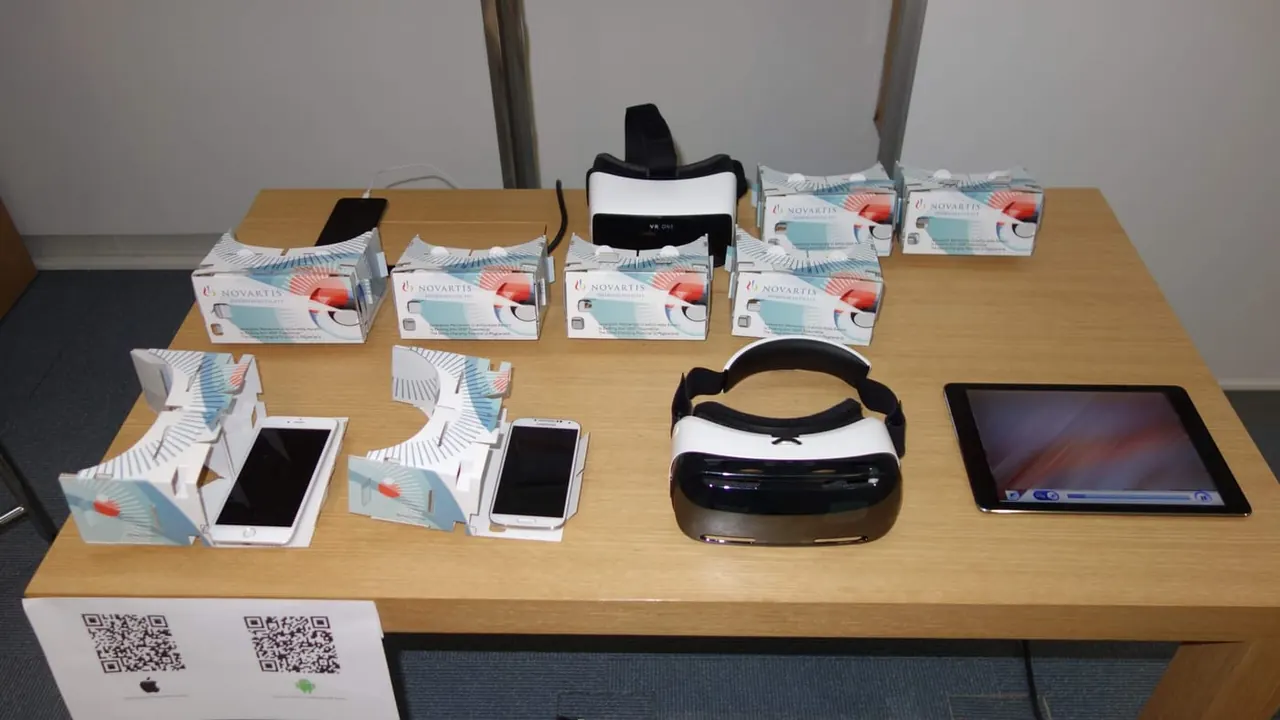 A table with VR headsets, phones and a tablet for the presentation