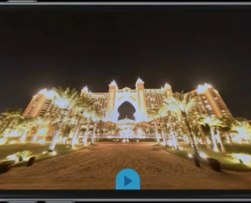 The illuminated façade of the Atlantis hotel at night, from the 360° panorama