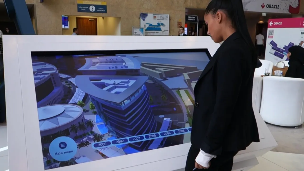 A woman at DAFZA’s large white touch table, the screen showing the 3D model of the area