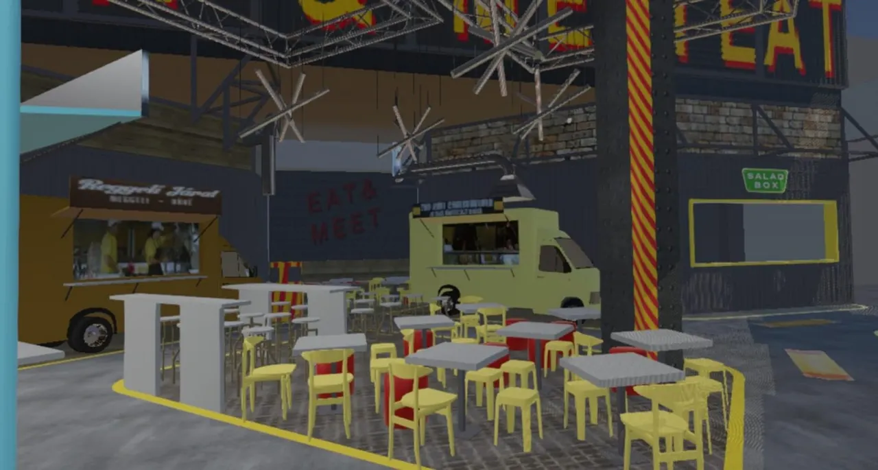 The ground floor of the planned Le Garage with a food truck and yellow chairs